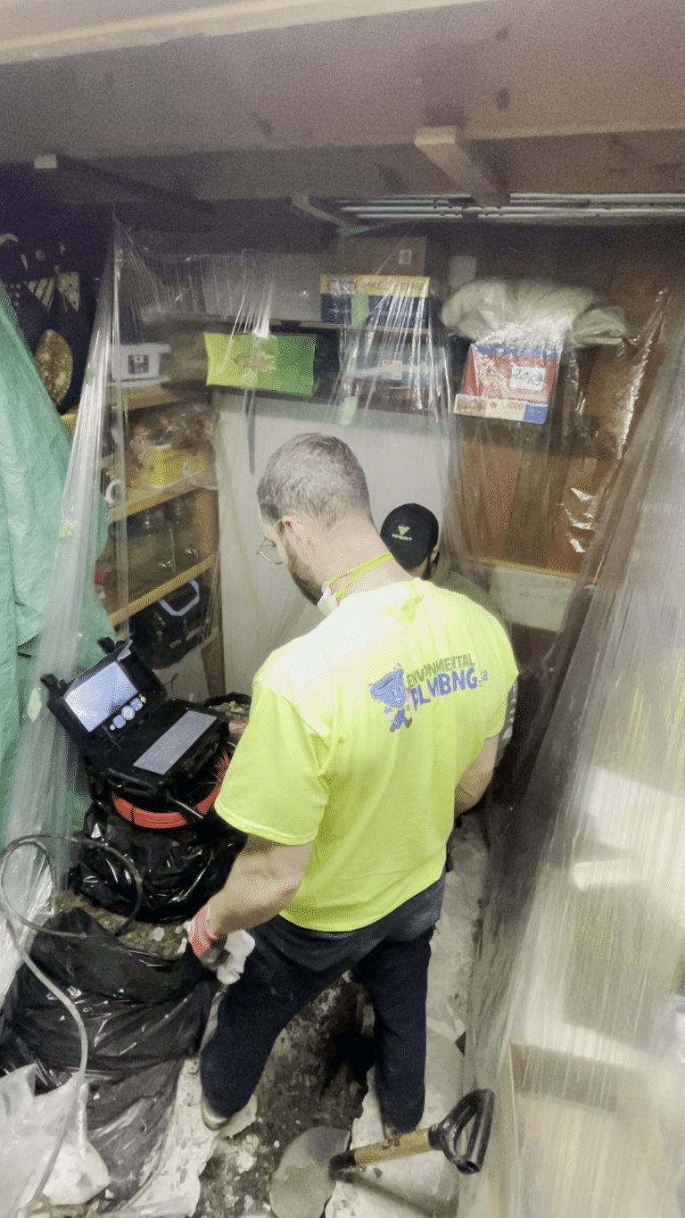 Environmental Plumbing technician operating drain camera inspection equipment