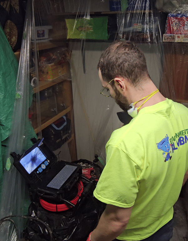 Environmental Plumbing plumber performing a camera drain inspection