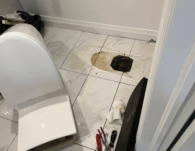 Toilet removed to access a difficult clog during a Kanata plumbing service