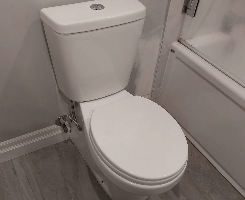 Rear-discharge toilet after plumbing repair