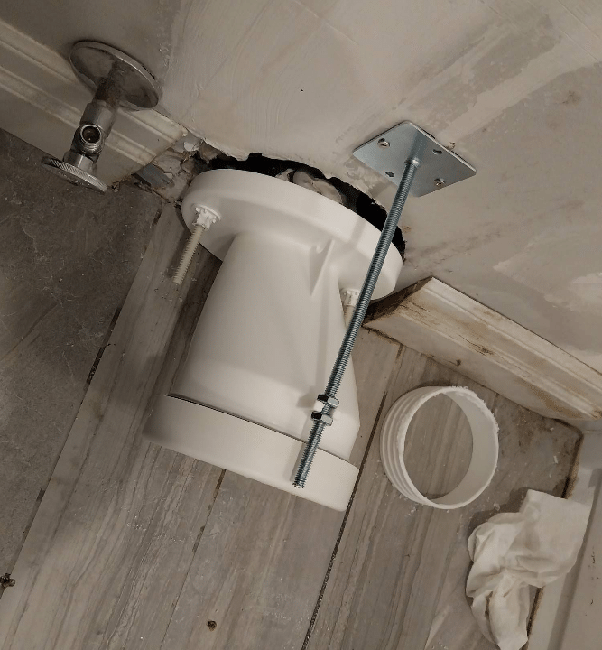 Rear-discharge toilet leak before plumbing repair